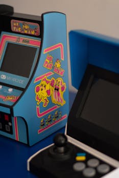 Colorful retro arcade machine and joystick in focus, perfect for gaming nostalgia.