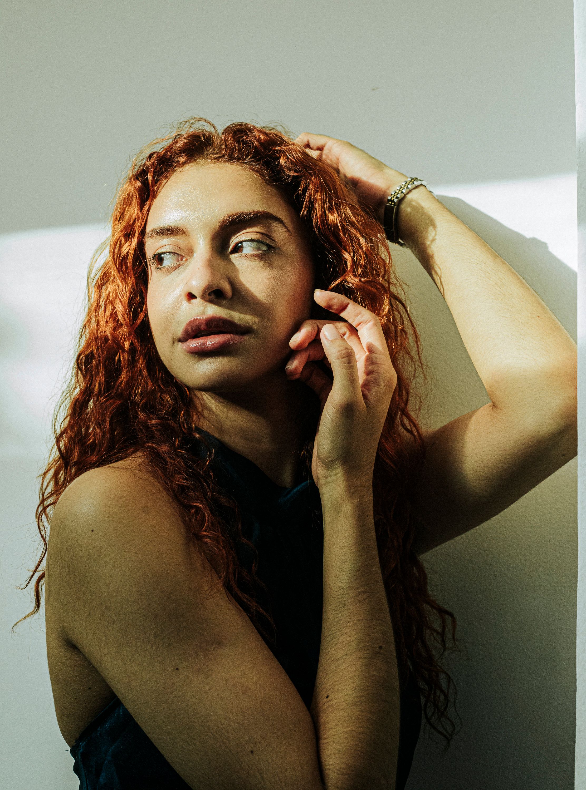 Portrait of Woman with Curly Red Hair in Sunlight · Free Stock Photo