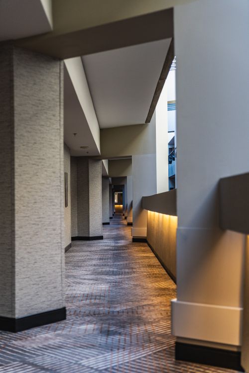 Free A sleek modern hallway featuring geometric architecture and soft lighting. Stock Photo