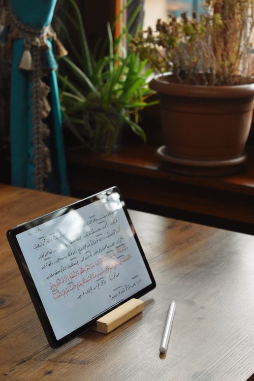 Free Tablet displaying handwritten notes in cozy indoor space with plants. Stock Photo