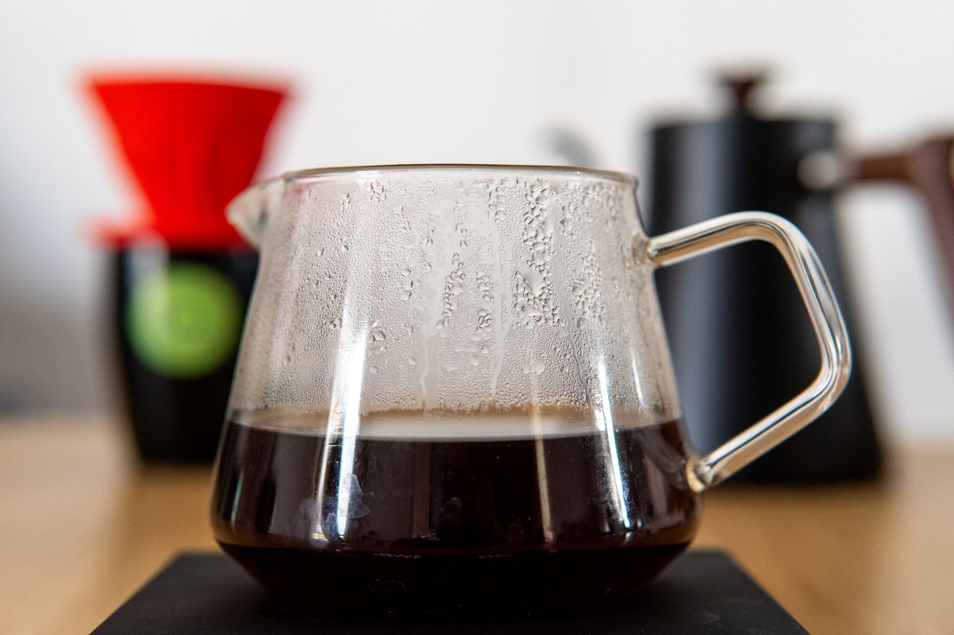Freshly brewed Gesha coffee in a clear glass cup showing its bright color
