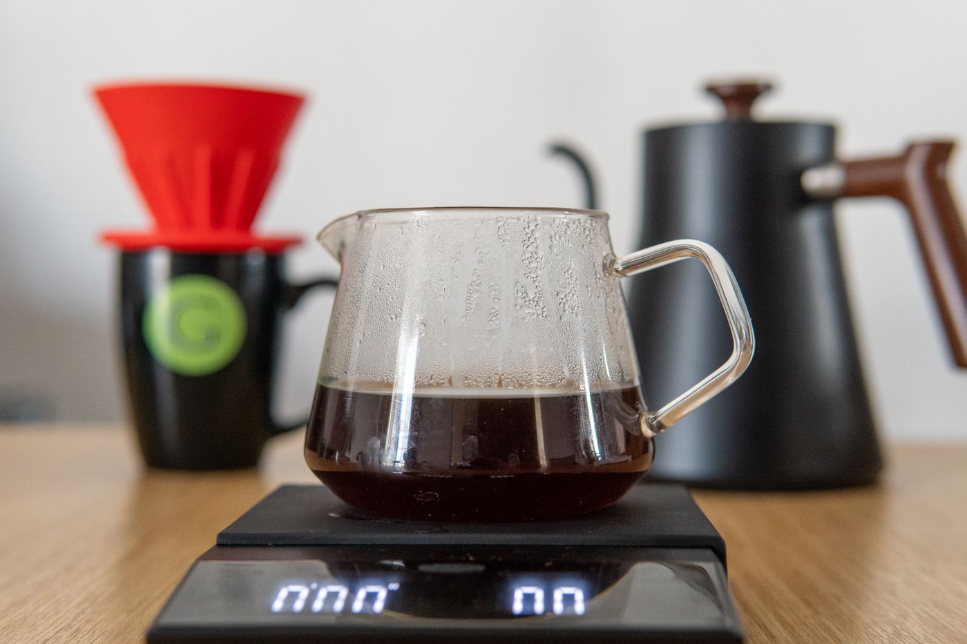 Pour-over coffee being brewed with a V60 dripper and glass carafe