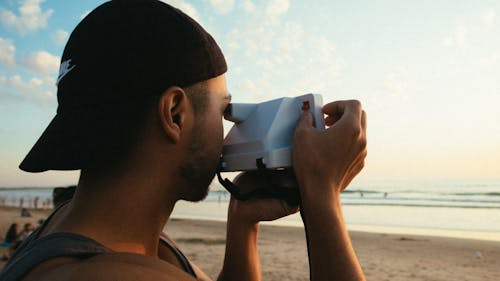 Man Using Instant Camera 