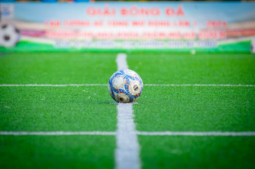 Close-up of a soccer ball on a green field in Hà Nội, Vietnam.