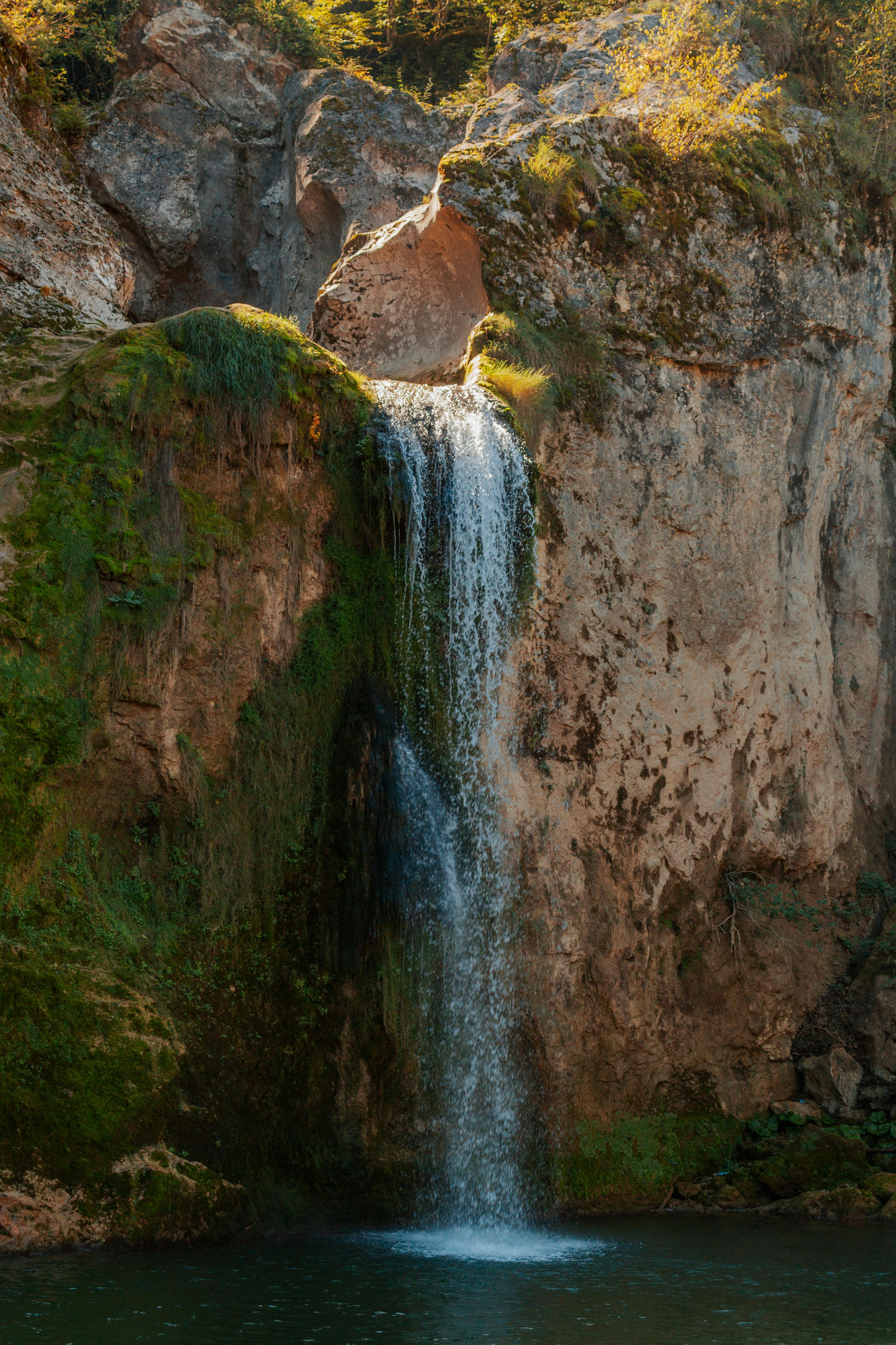 Serene waterfall cascading down a mossy rock face in Kastamonu, Turkey, during daytime.