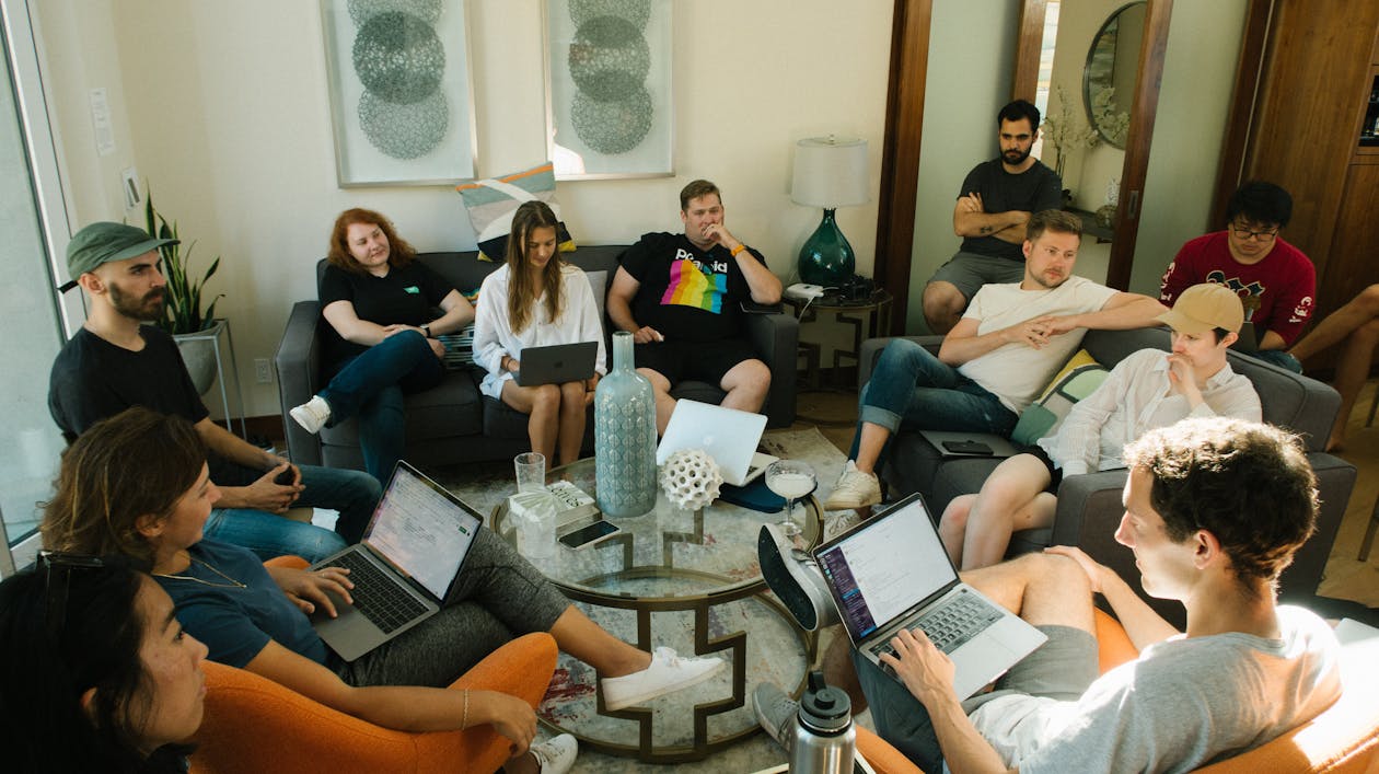 Free Group of People Sitting on Sofa While Discussing Stock Photo