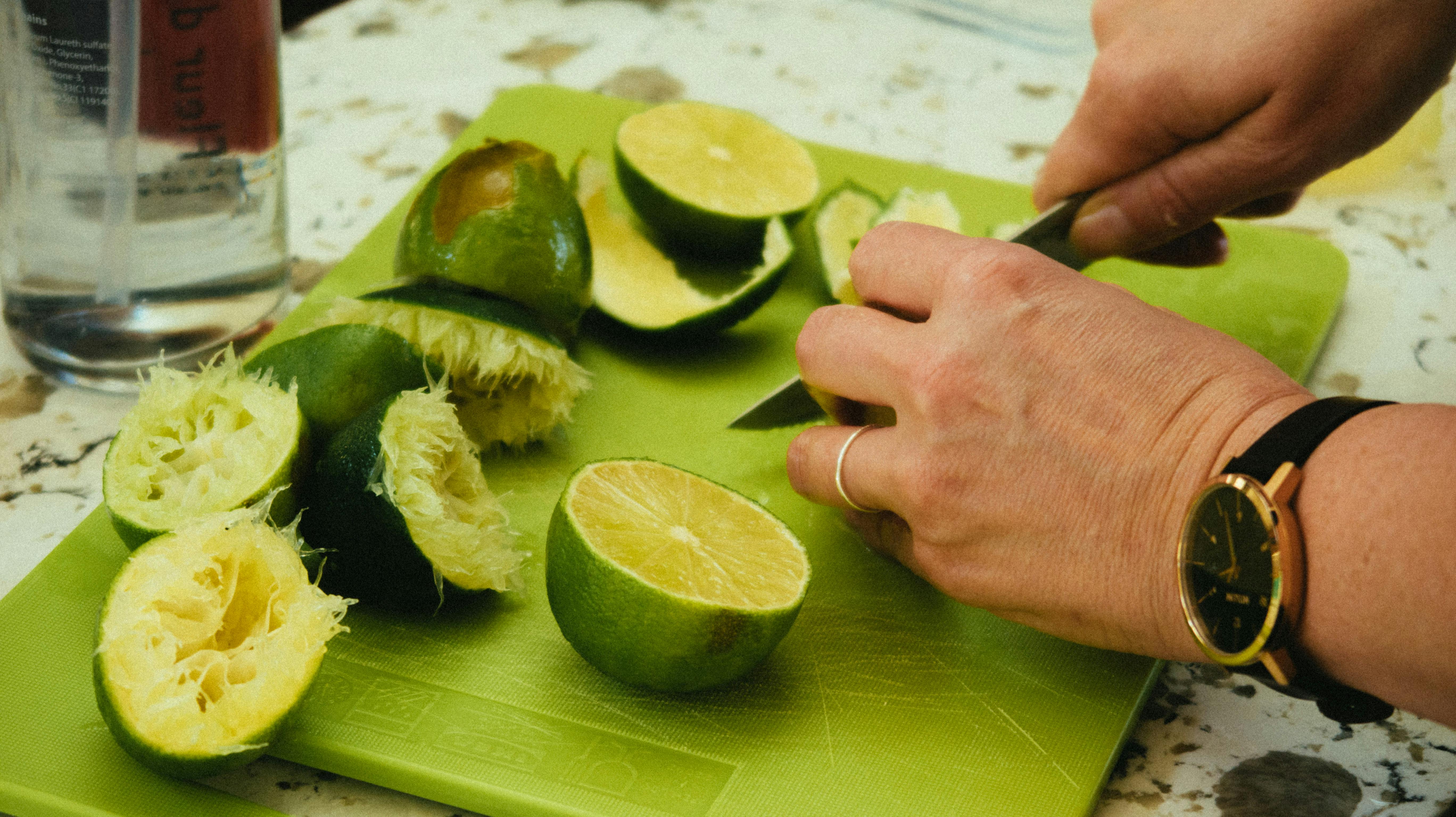 sliced limes on green chopping board