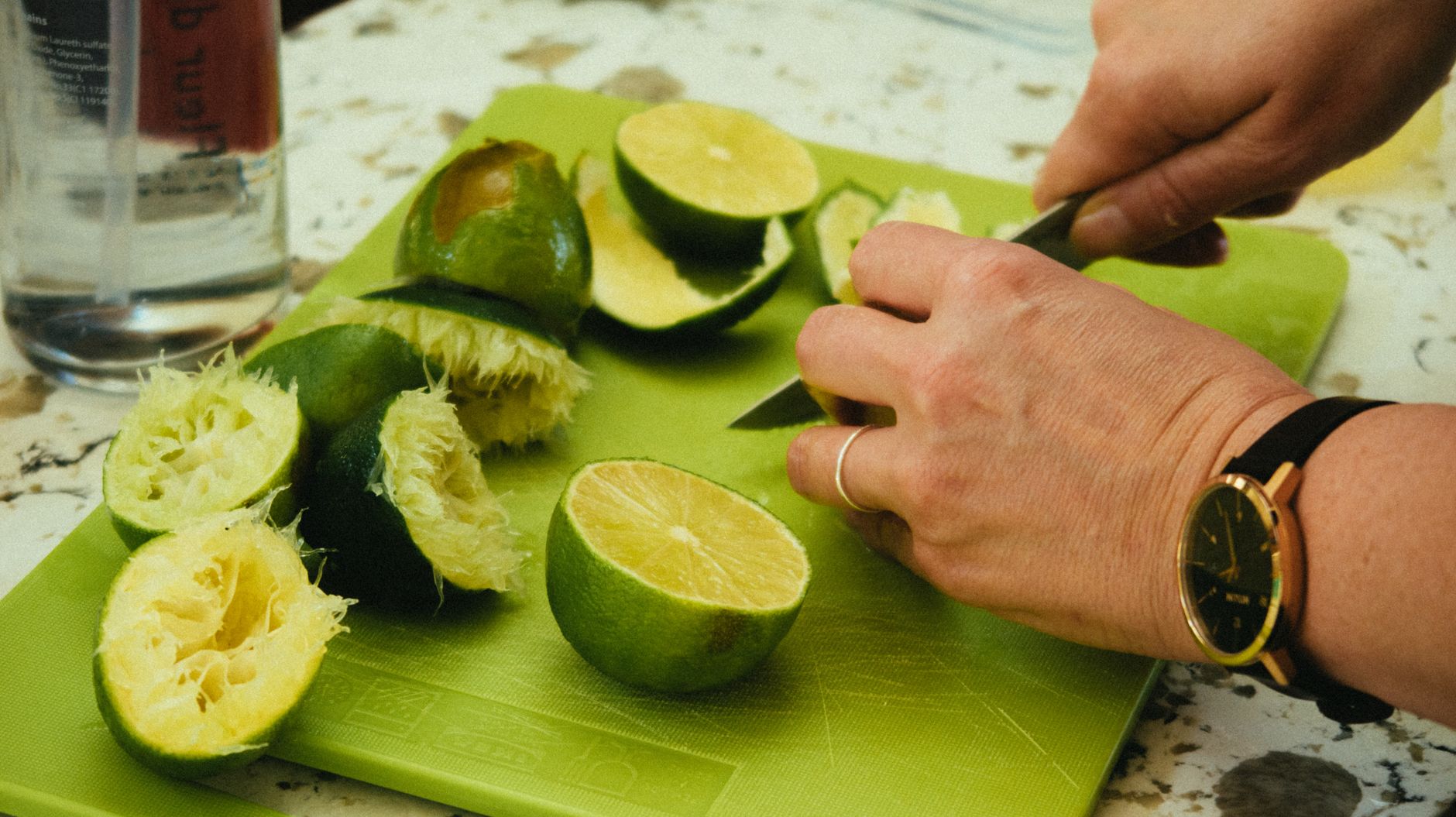 Freshly picked green limes placed on rustic wooden table