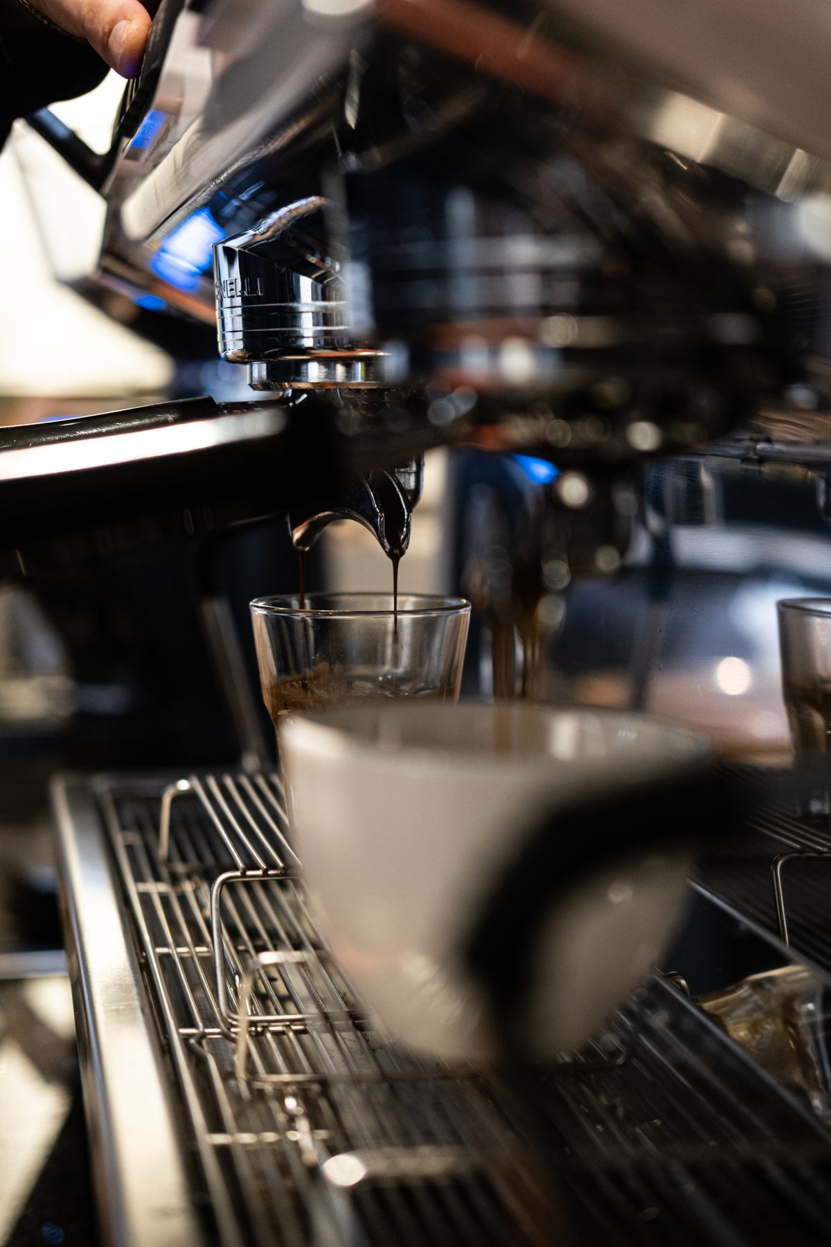 Barista pulling a shot on a high-end commercial machine, for illustration