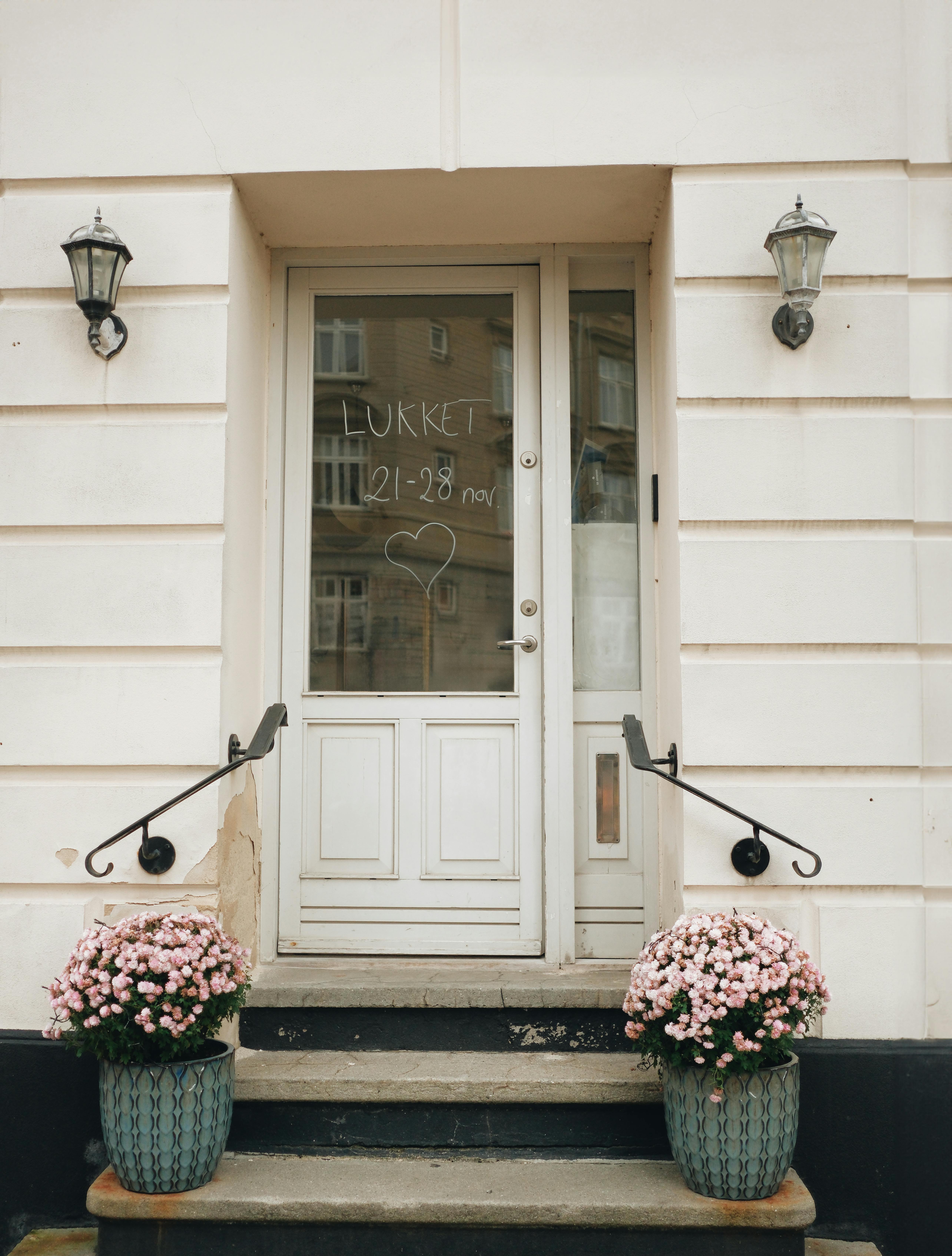 Front door with 'lukket' sign and flowers in Odense, Denmark.