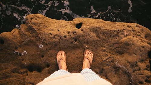 Free Person Standing On Cliff Wearing Brown Flip-flops Stock Photo