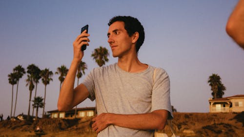 Photo Of Man Holding Smartphone