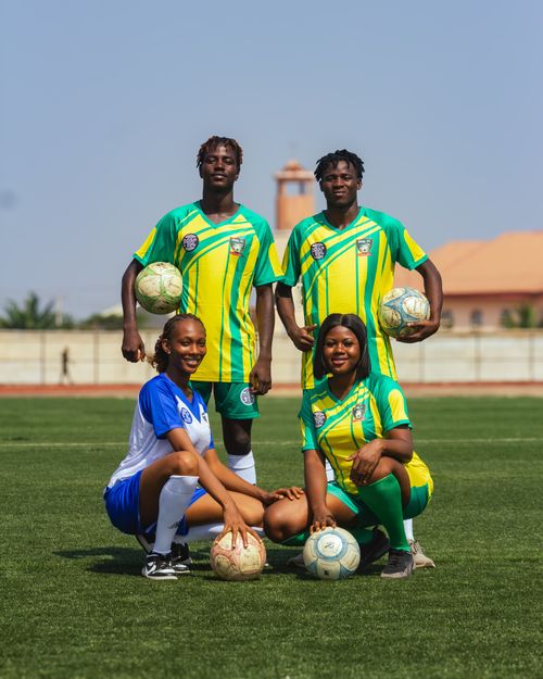 Free Group of young soccer players in team uniforms posing confidently on a sunny day. Stock Photo