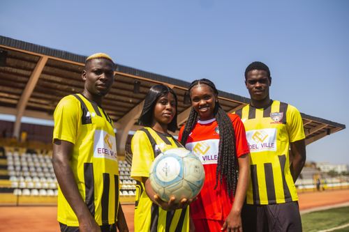 Free Group of young African football players posing on a sunny day in a stadium. Stock Photo