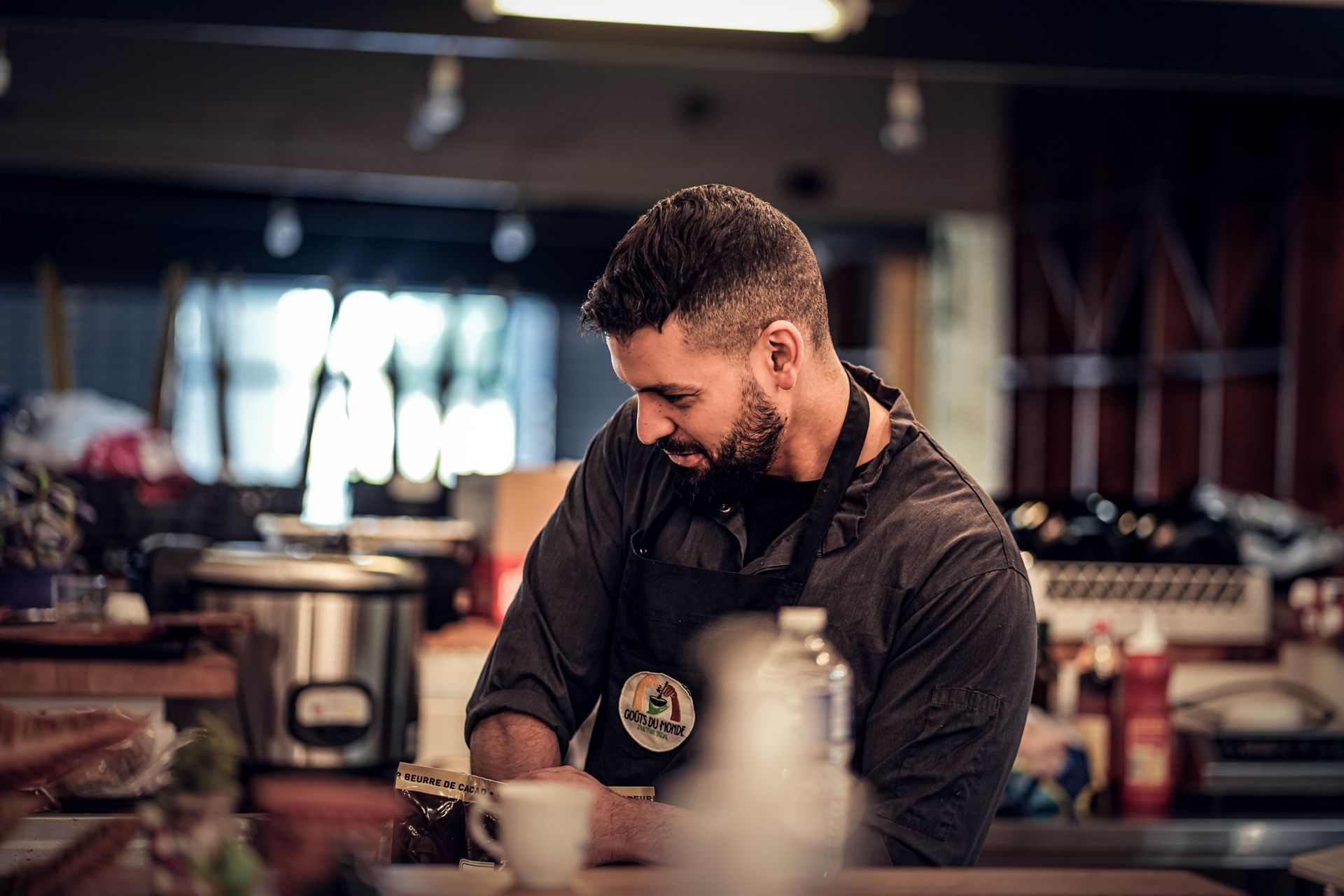 Chef preparing meal in a vibrant Marseille kitchen, showcasing culinary skills and focus.
