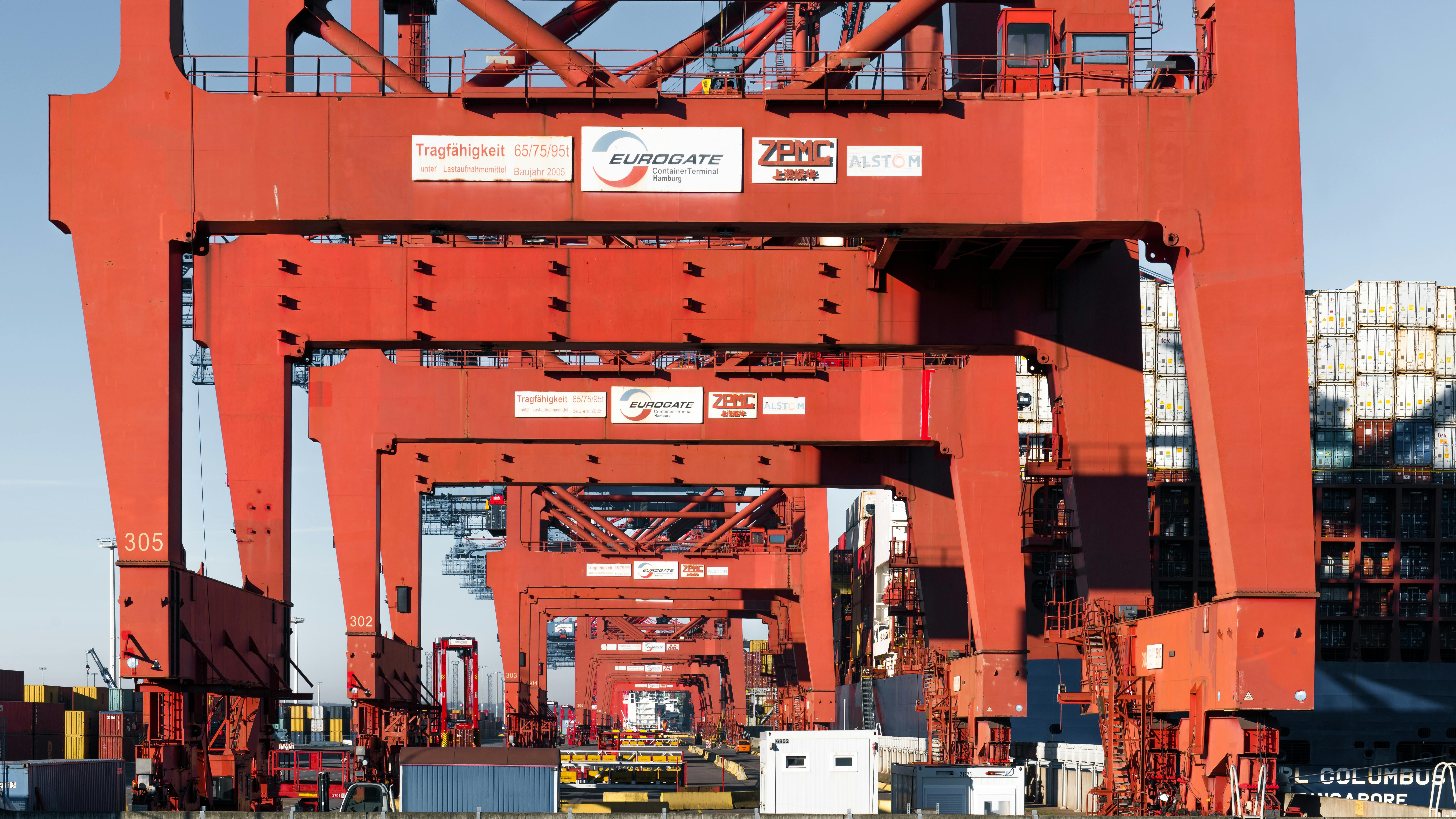 red cranes at container terminal in hamburg