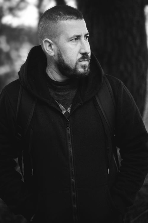 Free Striking black and white portrait of a man in a contemplative pose outdoors. Stock Photo