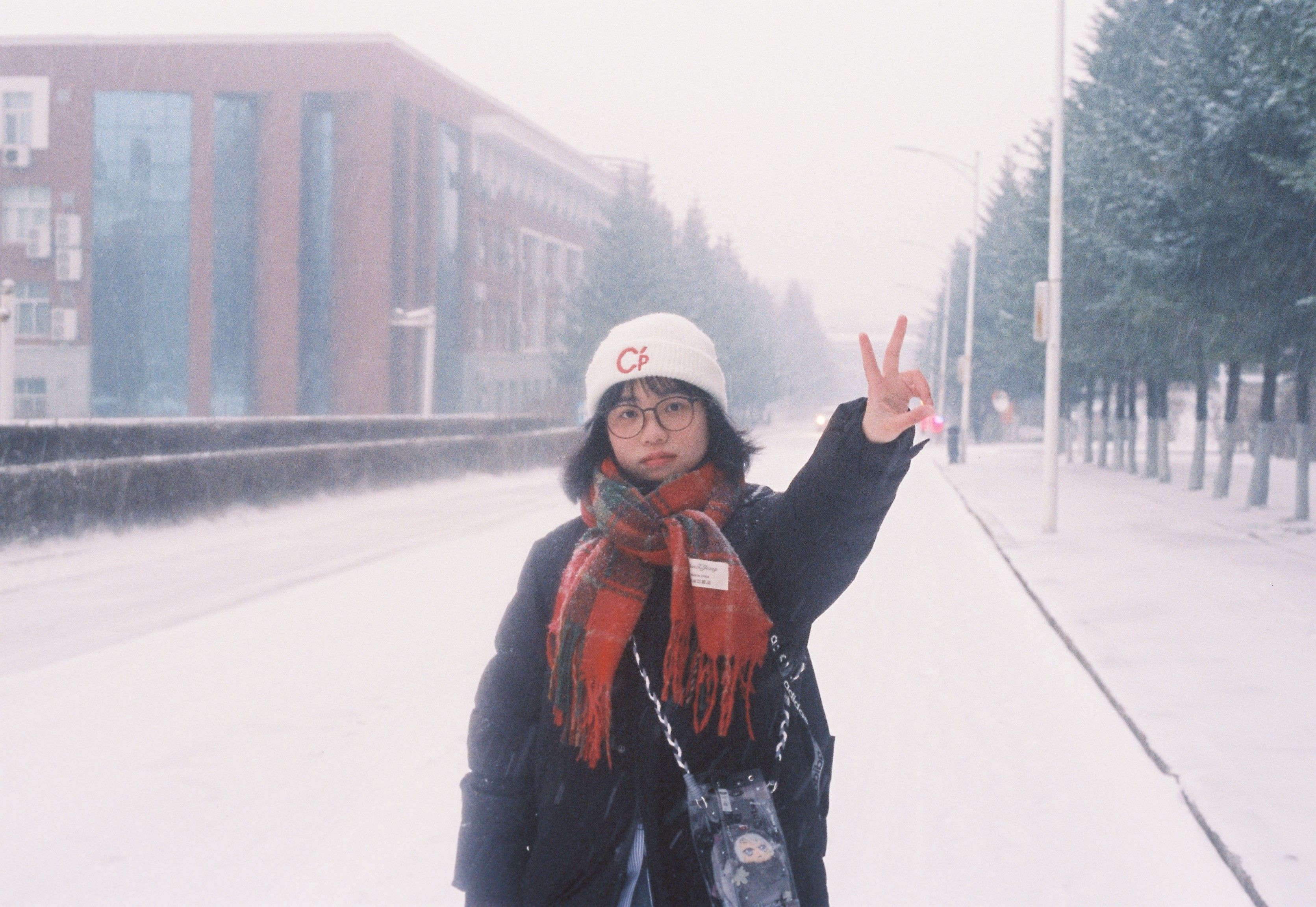 Customer smiling on a snowy city street, representing everyday banking customers