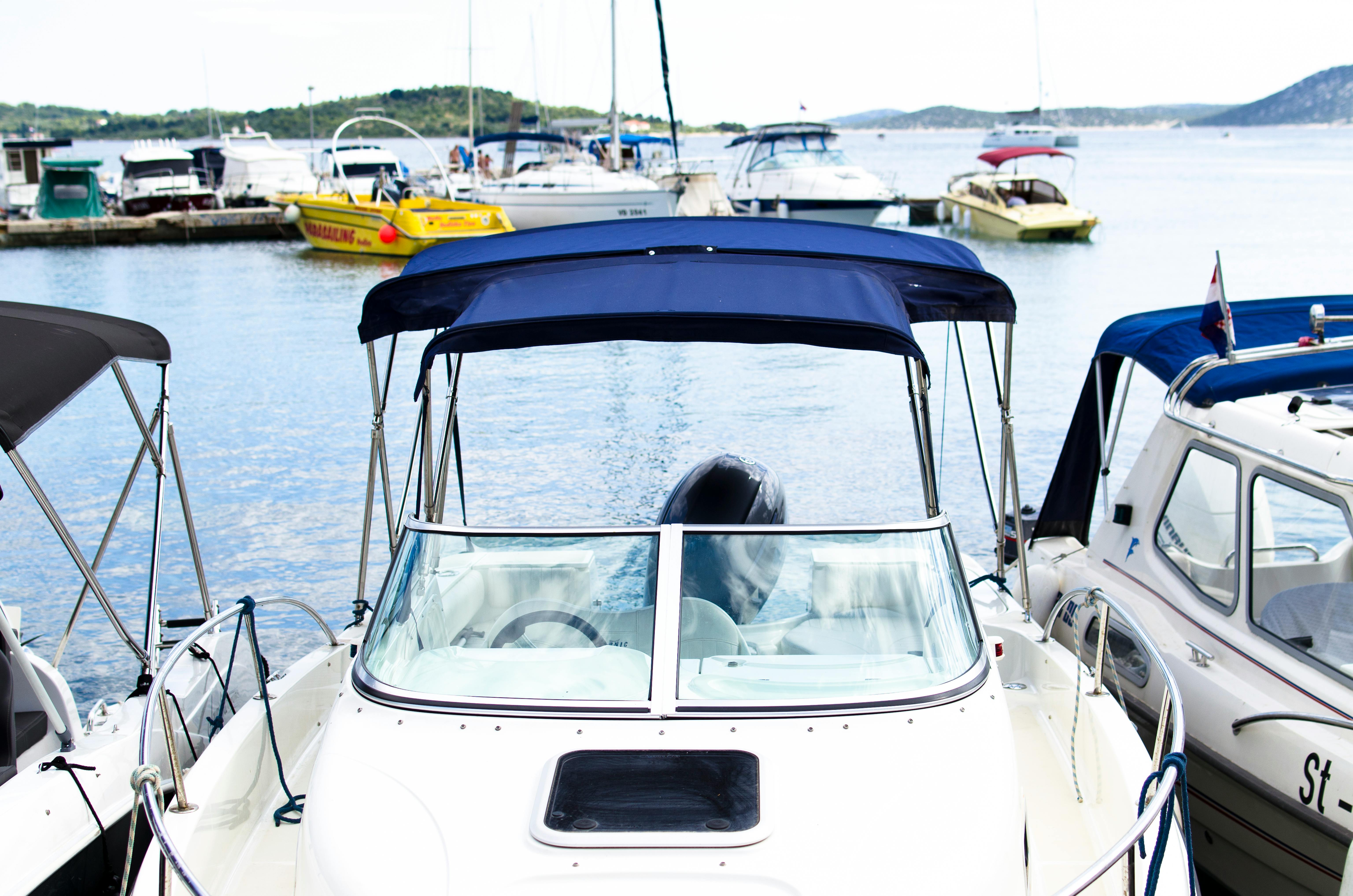 White And Blue Speedboat On Body Of Water · Free Stock Photo