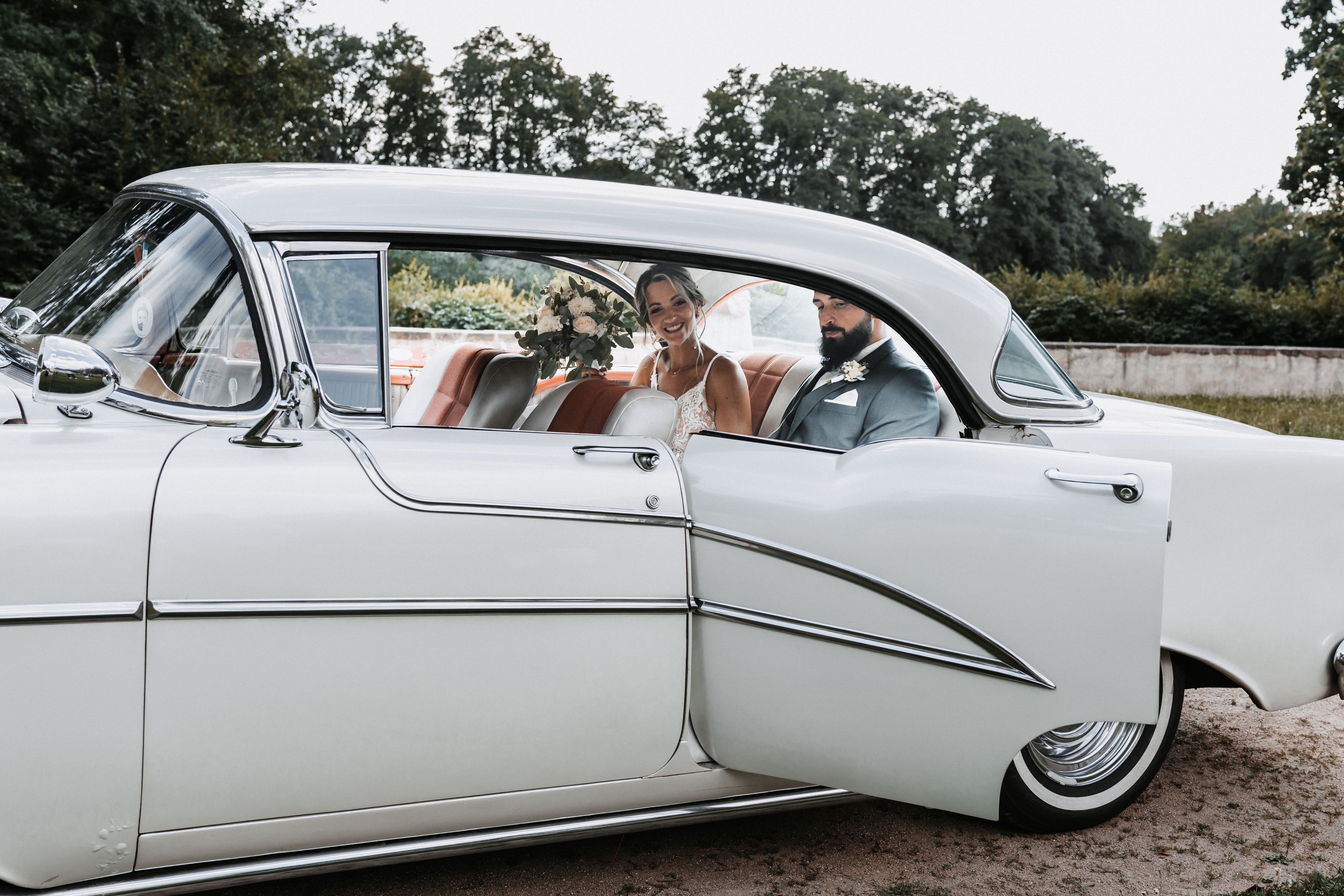 Bride and Groom in Vintage Wedding Car · Free Stock Photo