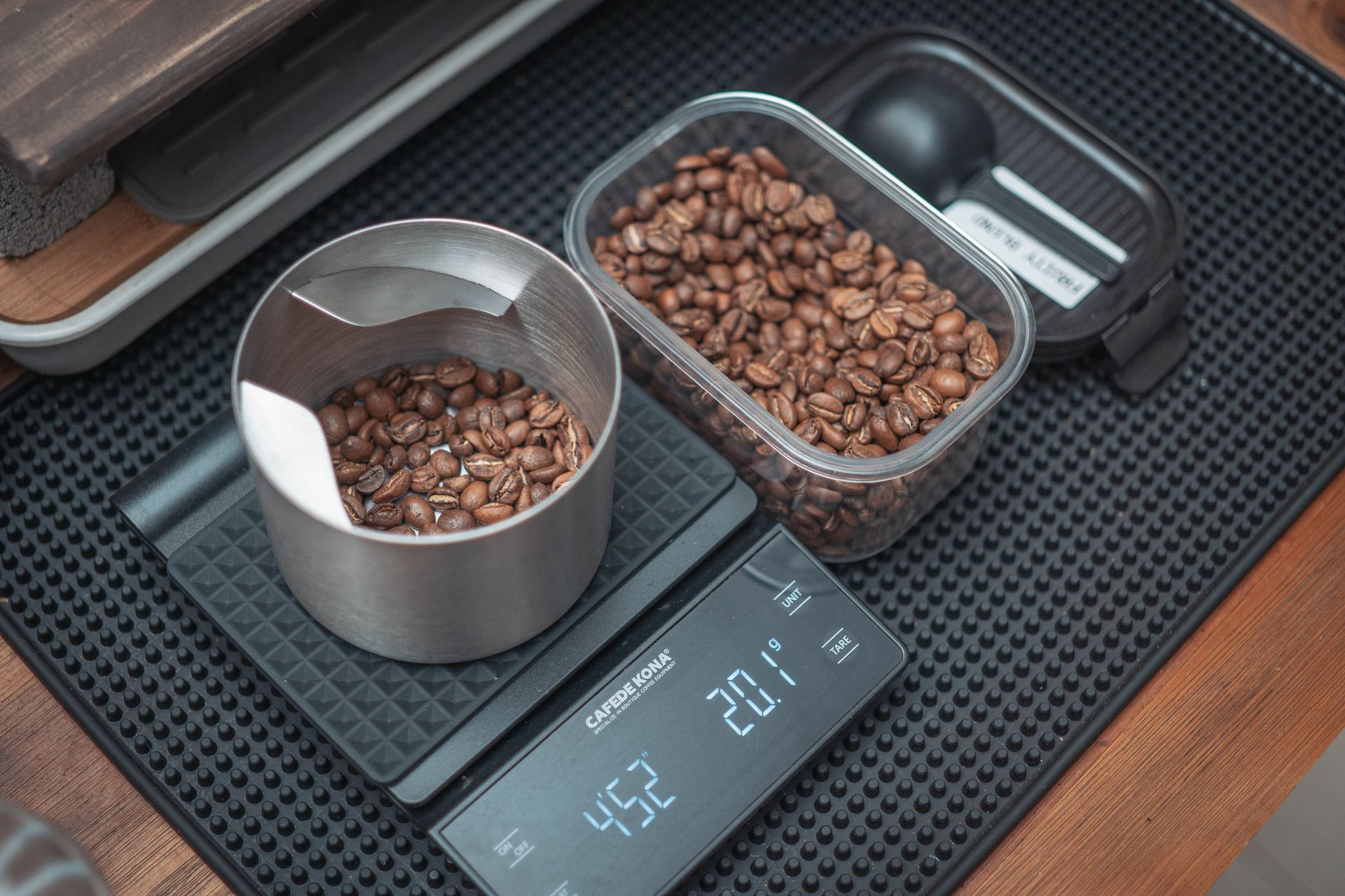 How to Spot Reprinted or Counterfeit Trading Card Booster Packs 3 A digital kitchen scale showing a booster box weight reading, with a sealed box on the scale, demonstrating the weight-check method