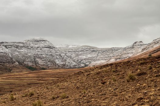 Stunning winter landscape of snow-dusted mountains in Teyateyaneng, Lesotho.