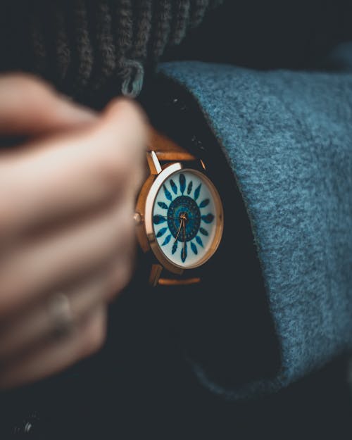 Person Wearing Gold Analog Watch