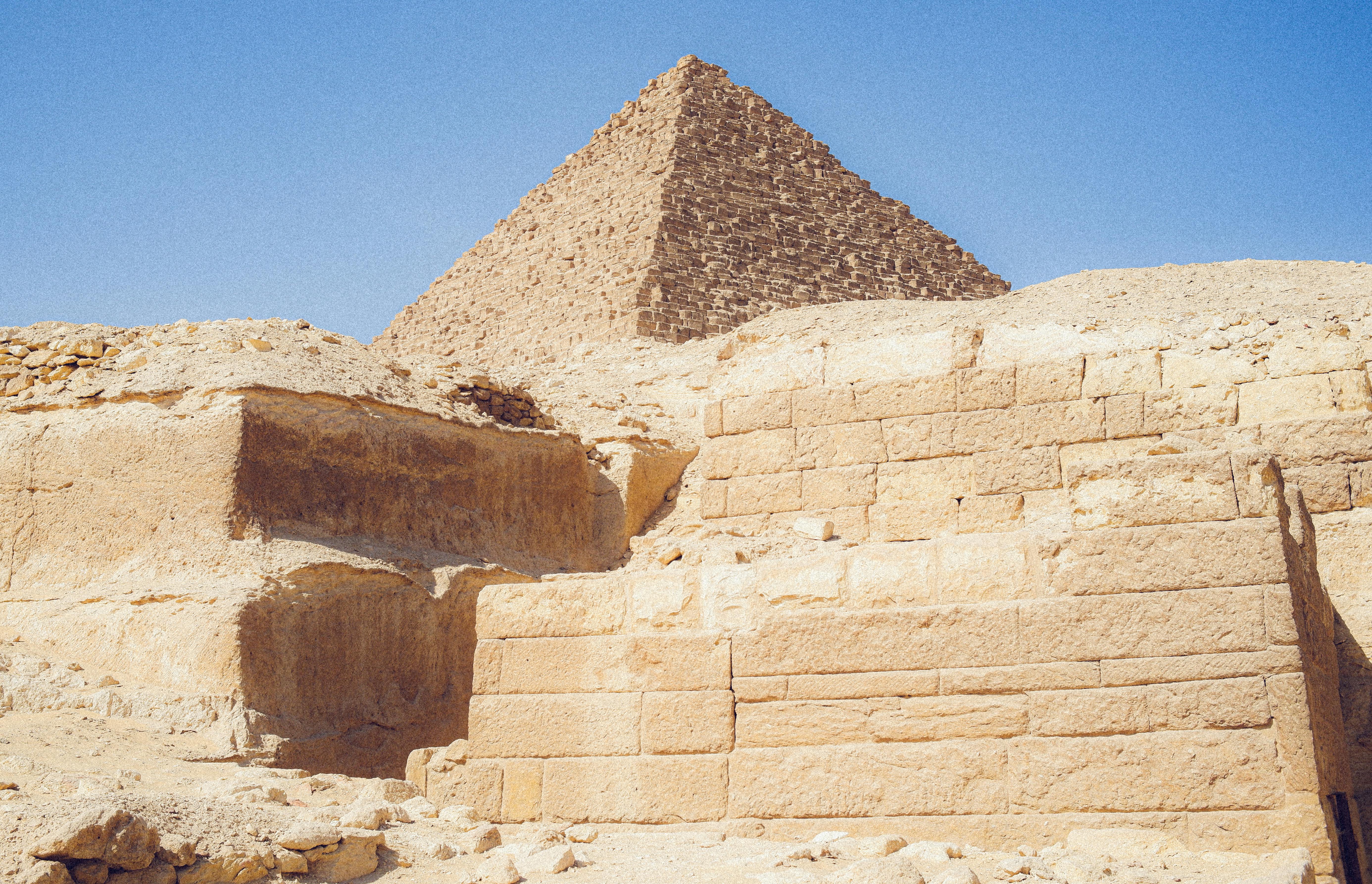 View of the Great Pyramid of Giza under a clear sky, showcasing ancient architecture and history.