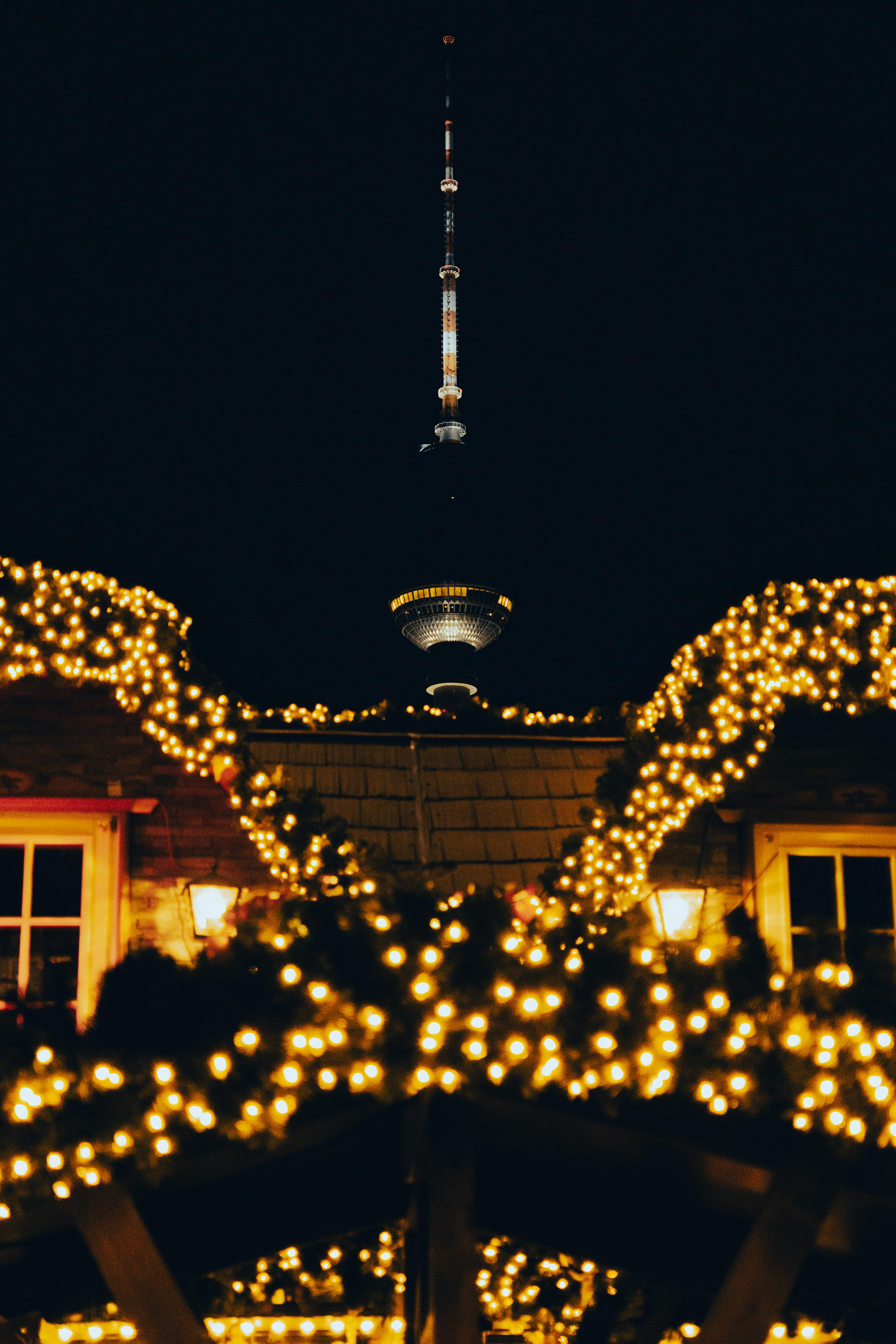 illuminated tv tower with twinkling lights at night