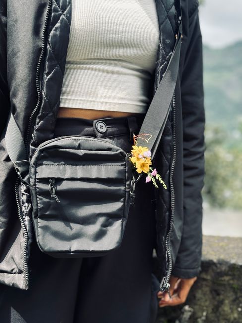 A woman wearing a small crossbody bag outdoors
