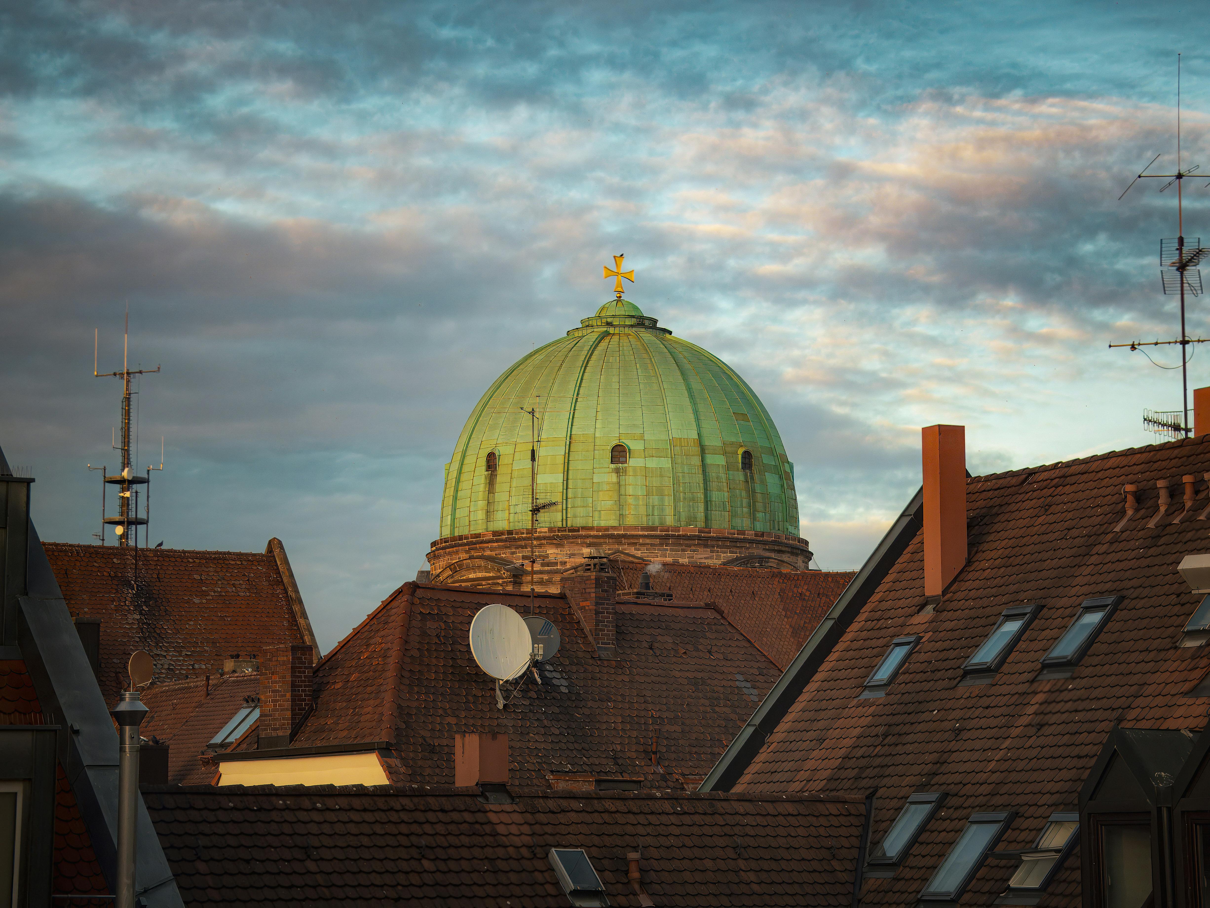 dome over rooftops with sunset sky background