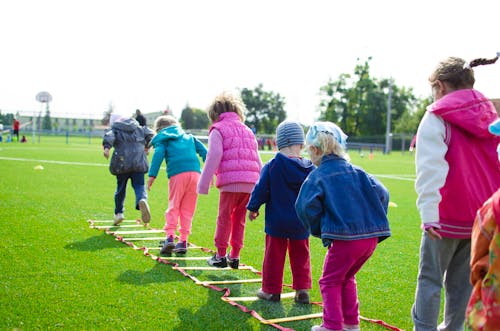 Free Children's Team Building on Green Grassland Stock Photo