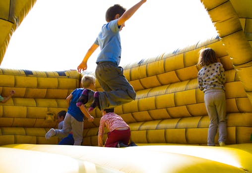 Children Playing on Inflatable Castle