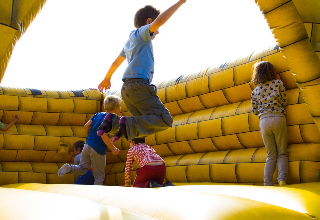 Children playing on an inflatable bounce castle