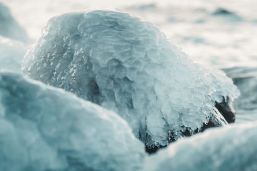 Close-up of ice-covered stones capturing a magical winter atmosphere in Estonia.