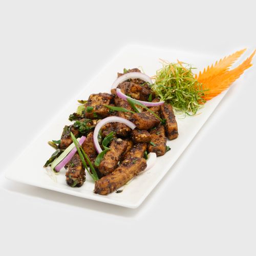 Free A gourmet plate of stir-fried tofu with crisp vegetables garnished beautifully. Stock Photo