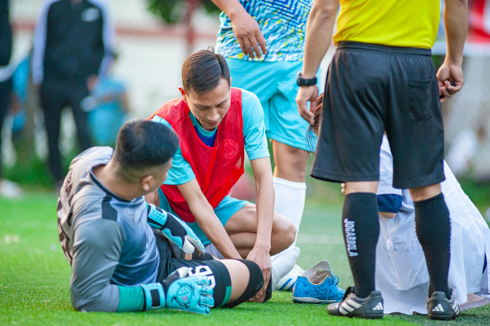 A soccer player receives assistance after an injury during a match in Hanoi, Vietnam.