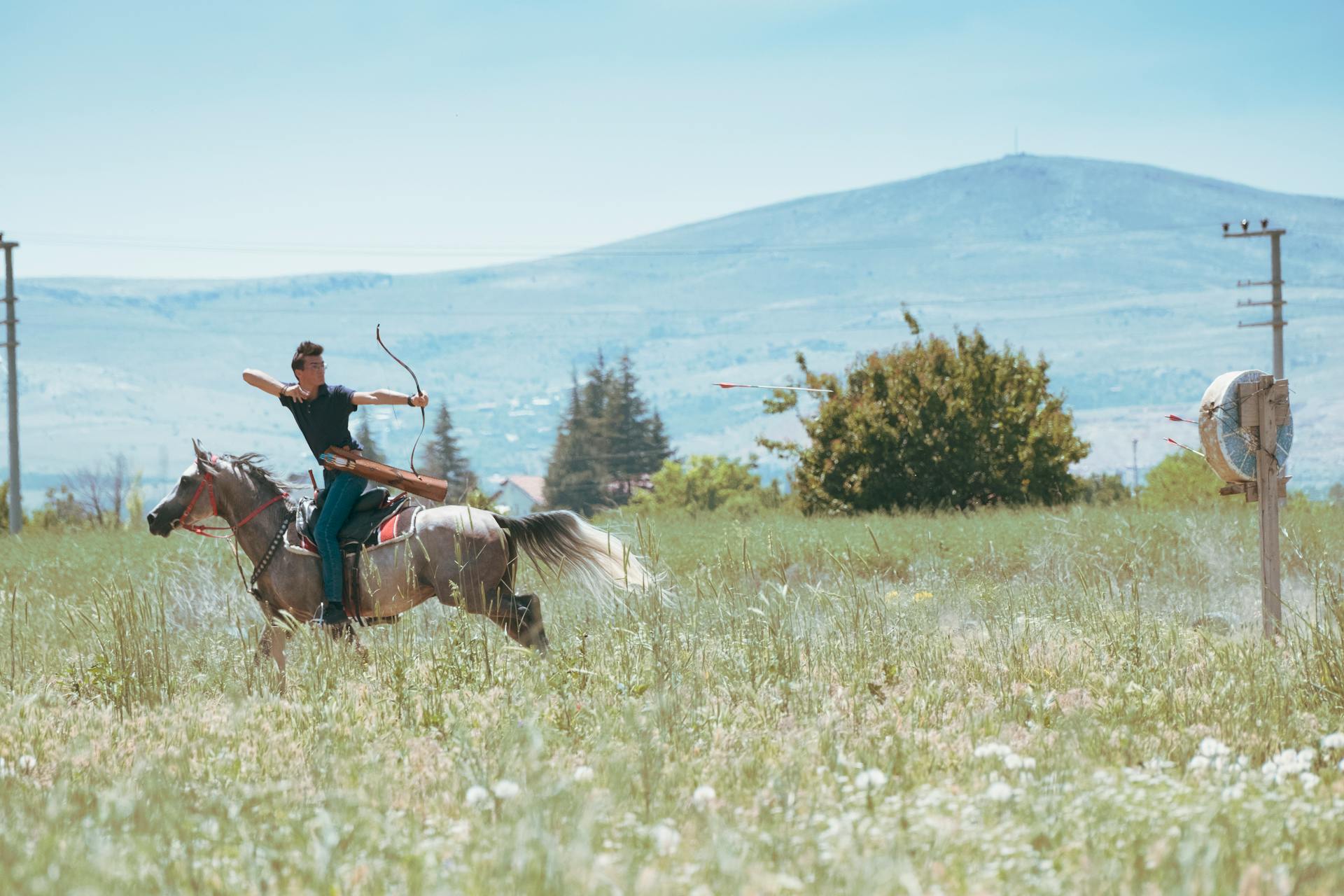 A skilled archer rides horseback in Konya's fields, capturing tradition.