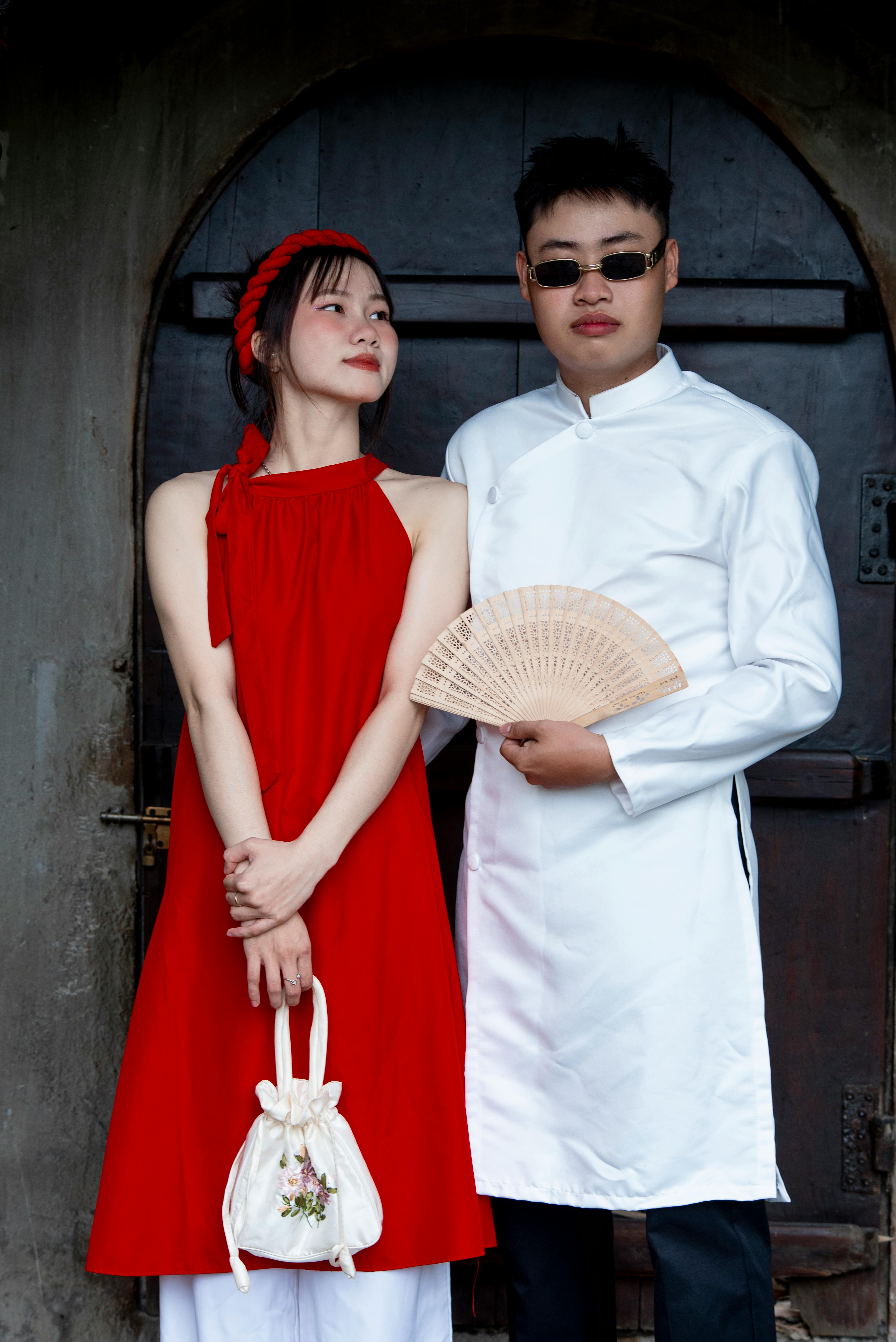 couple in traditional asian attire posing outdoors