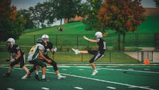 在充满活力的绿地上，美式橄榄球运动员们正进行着激动人心的比赛