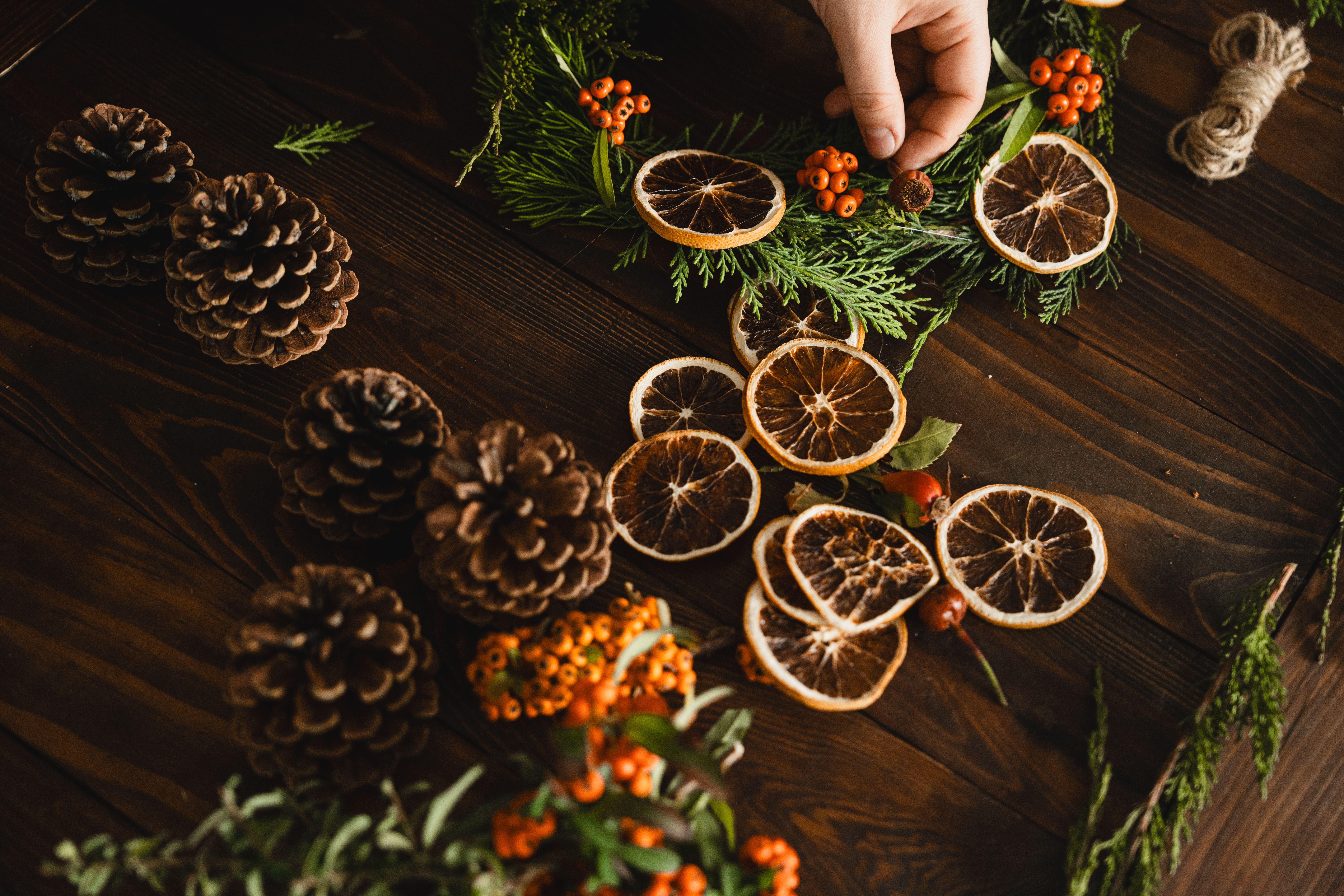 Dried orange slices and pinecones arranged as holiday decor - recycled holiday decorations