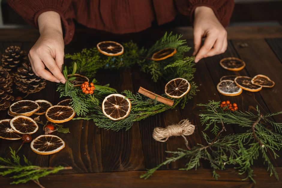 Dried Orange Garland DIY home decor project — Crafting a Christmas wreath with dried oranges and pine cones adds a natural holiday touch.