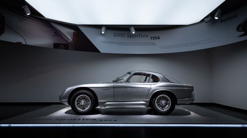 Free Side view of the vintage 2000 Sportiva 1954 car displayed in a dimly lit museum setting. Stock Photo