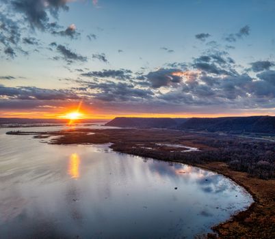 A breathtaking sunset over the Mississippi River in Weaver, Minnesota. Reflective waters and vivid sky.