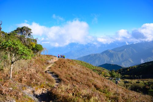 Free Hikers enjoying a scenic view on a mountain trail in Lào Cai, Vietnam. Stock Photo