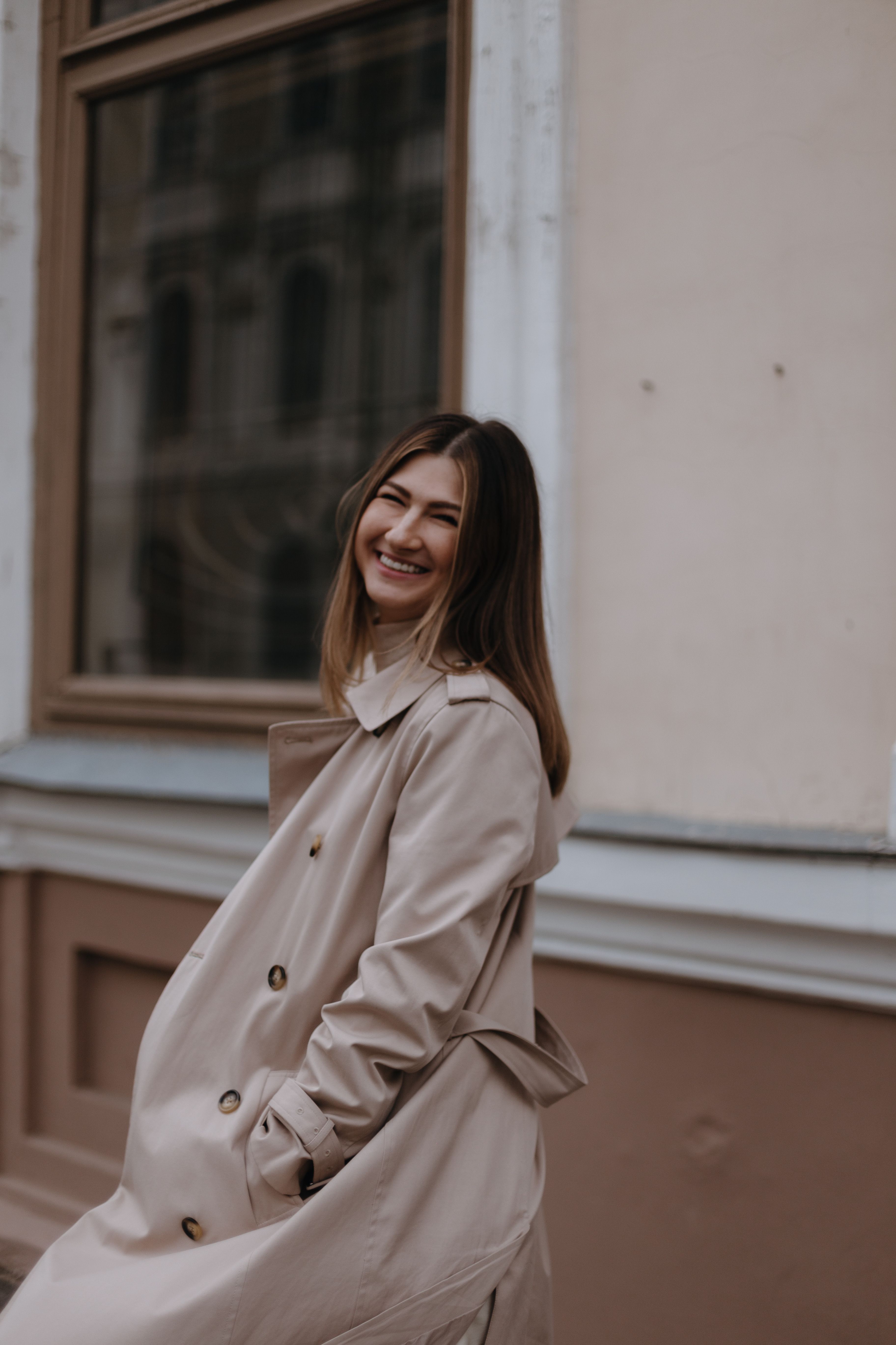 Smiling Woman in Stylish Beige Trench Coat Outdoors · Free Stock Photo
