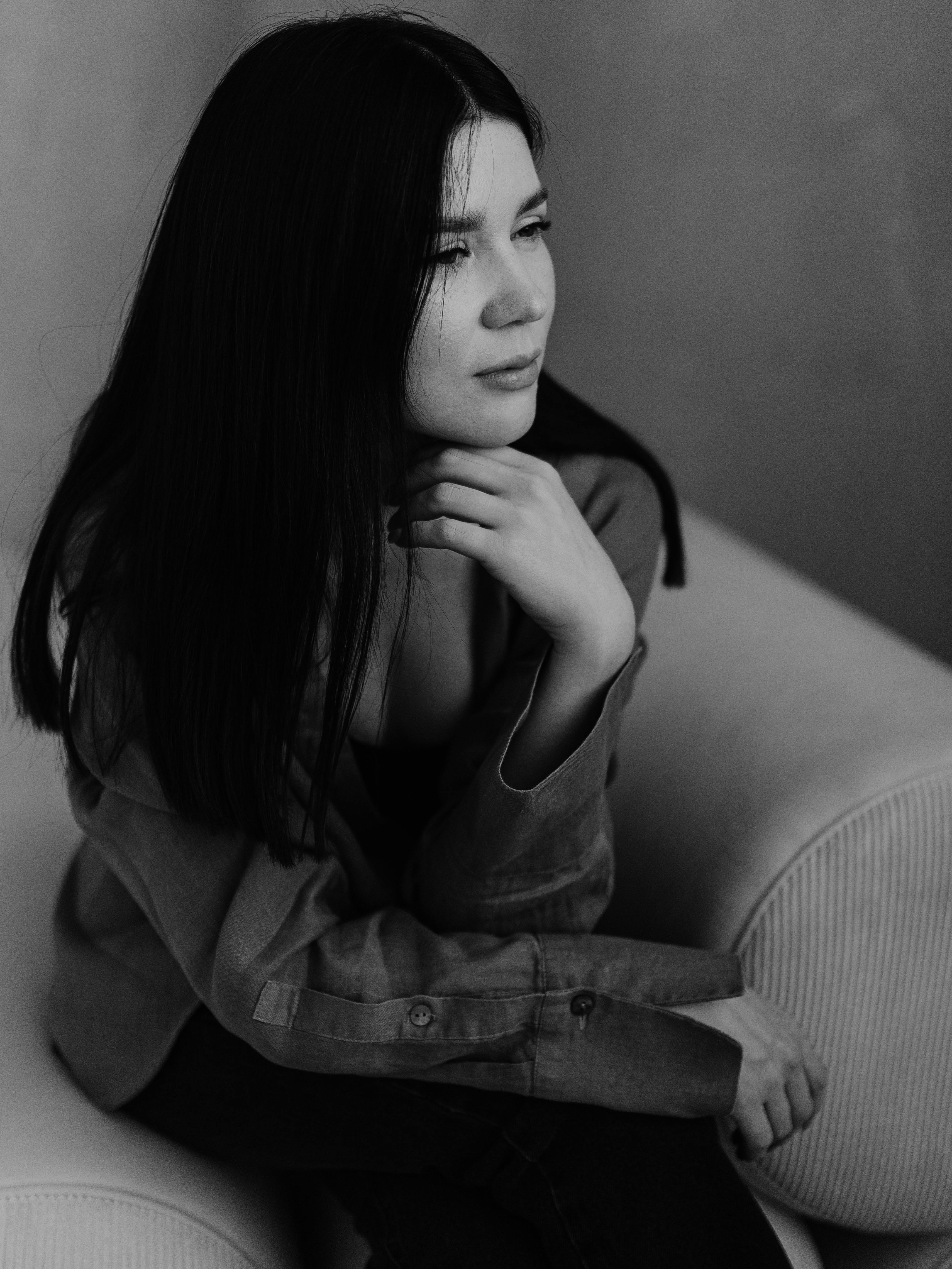 contemplative black and white portrait of woman indoors