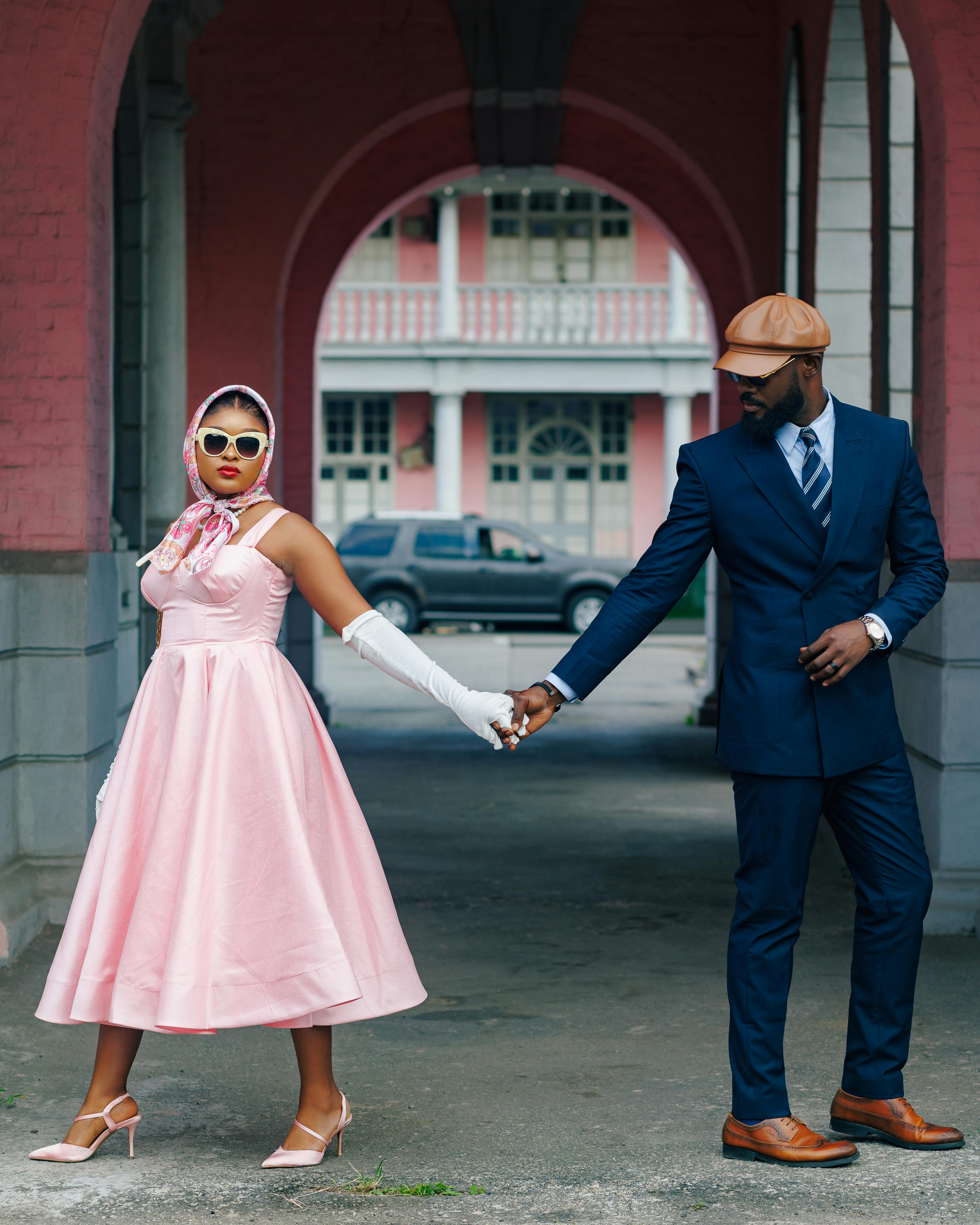 Free Stylish couple in vintage fashion holding hands in an urban setting. Stock Photo