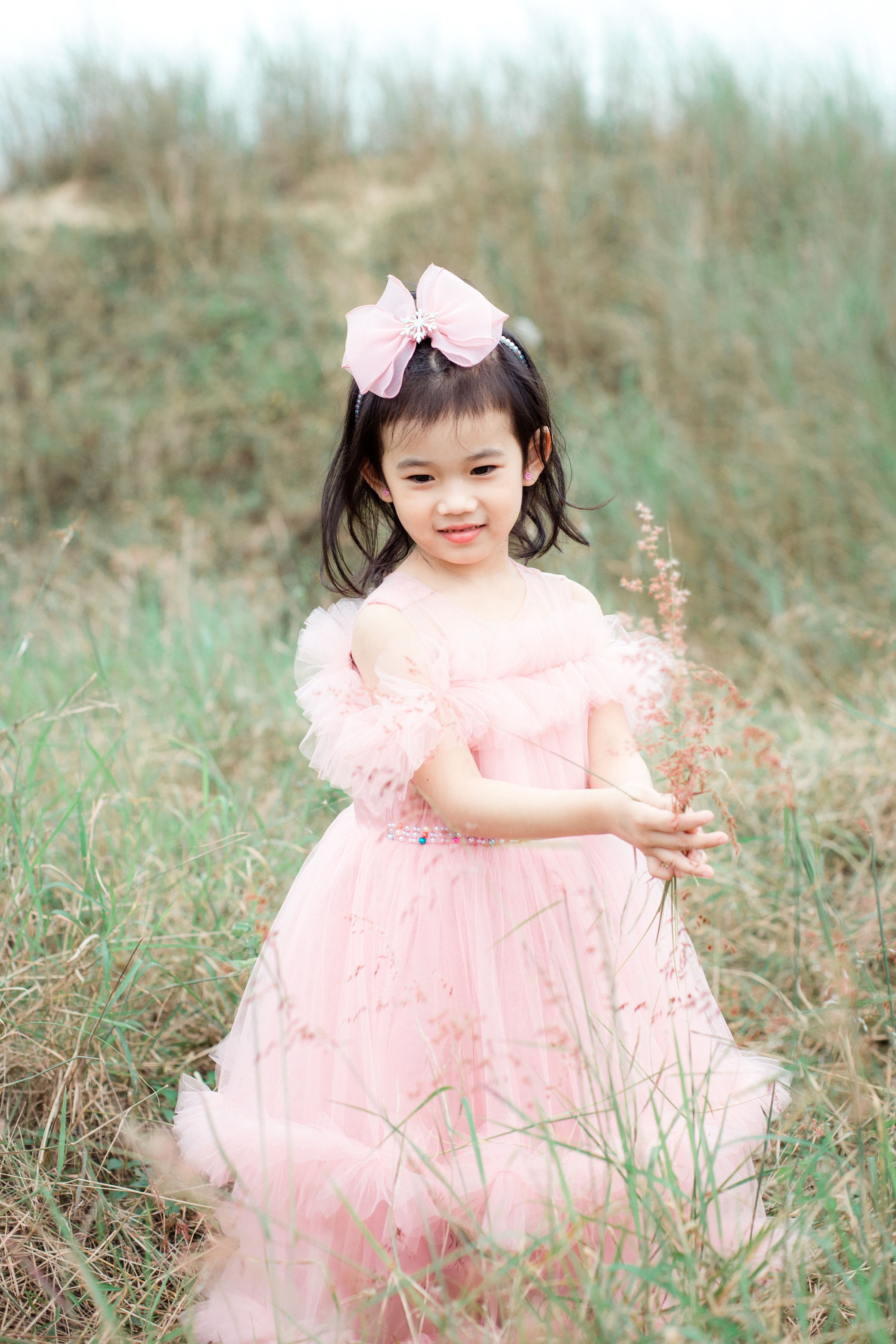 Charming Child in Pink Dress Outdoors · Free Stock Photo