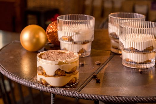 Delicious tiramisu dessert served in a cozy cafe setting with festive ornaments.